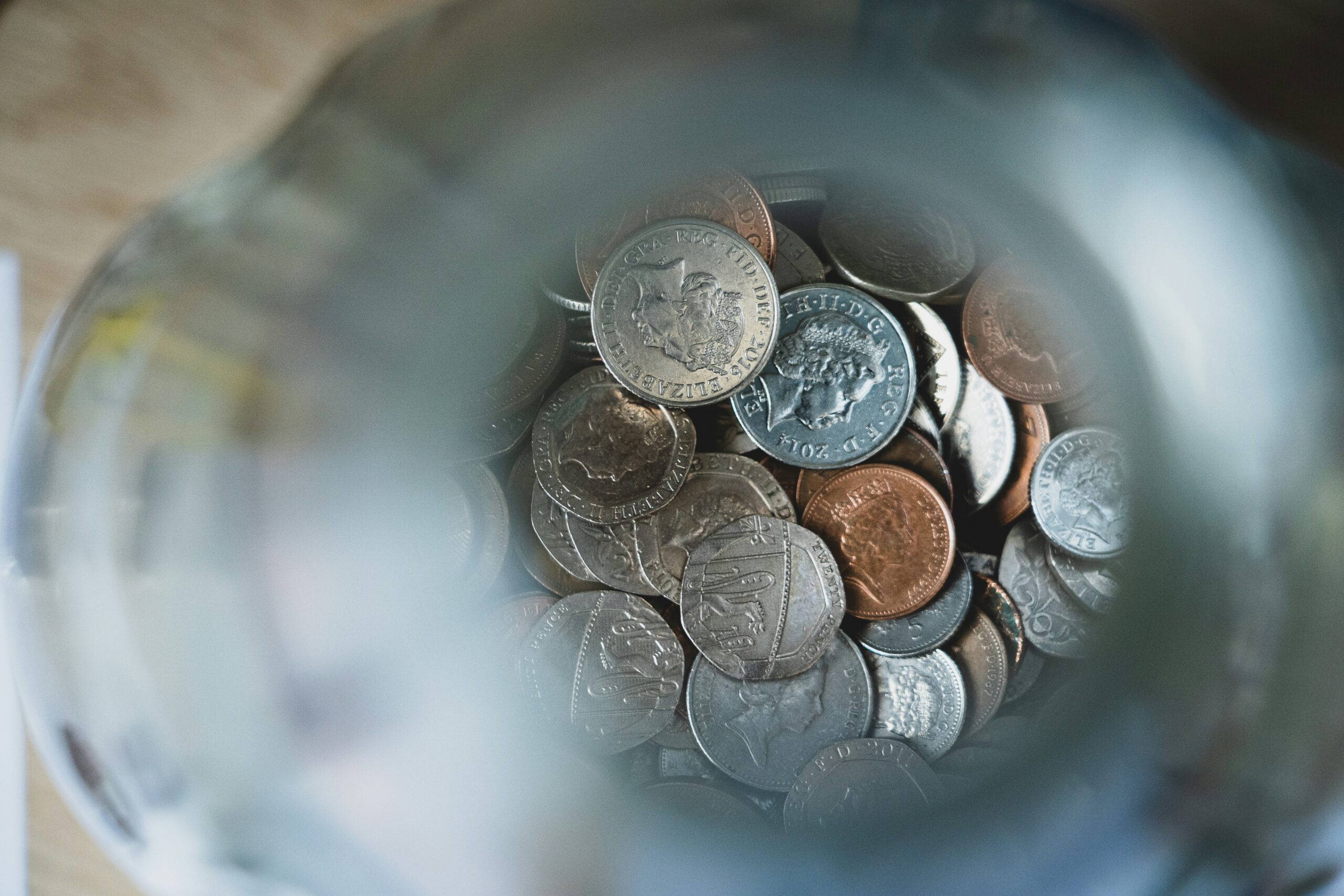 a picture of some money: coins in a jar