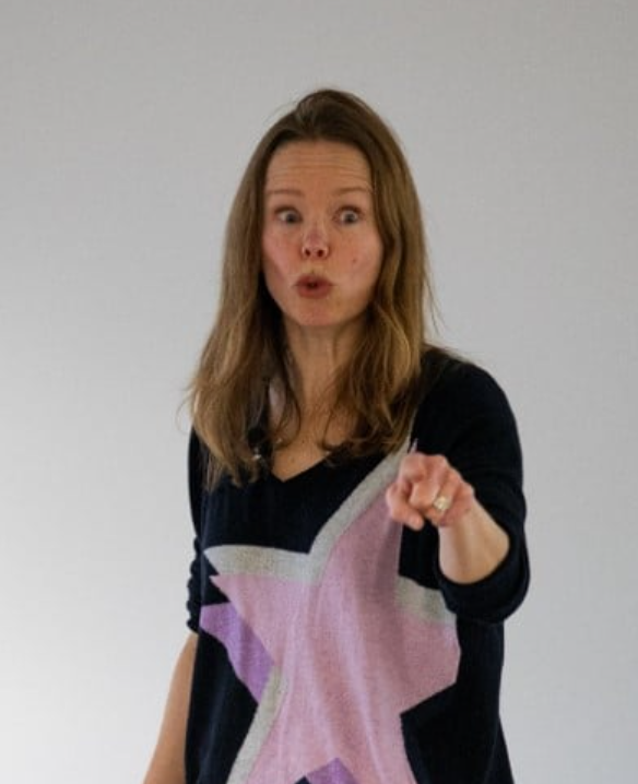 A photograph of Toni delivering a keynote speech. she is pointing with her left hand and looks like she's saying "get out of my pub". This is what the 49er wants!